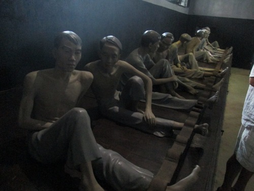 Life-size model of inmates sitting in row